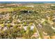 Wide aerial shot features a quiet residential area, with mature trees, and a community pool nearby at 3614 Twisted Oak Ct, Lake Wales, FL 33898