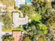 Aerial view of a beautiful home showcasing mature landscaping and serene backyard spaces at 3614 Twisted Oak Ct, Lake Wales, FL 33898