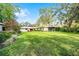 Expansive green backyard offering plenty of space and views of the home at 3614 Twisted Oak Ct, Lake Wales, FL 33898