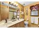 Cozy bathroom with dual vanity, decorative accents and a shower with glass door at 3614 Twisted Oak Ct, Lake Wales, FL 33898