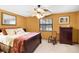Comfortable bedroom featuring a ceiling fan, natural light, and neutral carpeting at 3614 Twisted Oak Ct, Lake Wales, FL 33898