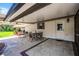 Covered patio with stamped concrete, ceiling fan, table and chairs, and an entrance to the home at 3614 Twisted Oak Ct, Lake Wales, FL 33898