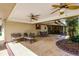 Covered patio with stamped concrete, ceiling fans, and outdoor seating, perfect for entertaining guests at 3614 Twisted Oak Ct, Lake Wales, FL 33898