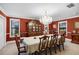 Formal dining room with chandelier, rich red walls, and a grand china cabinet for elegant entertaining at 3614 Twisted Oak Ct, Lake Wales, FL 33898