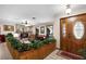 Inviting foyer with a decorative wood accent wall, tiled floors, and a charming leaded glass door at 3614 Twisted Oak Ct, Lake Wales, FL 33898