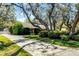 Charming one-story home with a well-manicured lawn, flowering bushes and shade trees in the front yard at 3614 Twisted Oak Ct, Lake Wales, FL 33898
