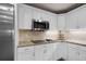 Gourmet kitchen with granite countertops, custom cabinets, and stainless steel appliances at 3614 Twisted Oak Ct, Lake Wales, FL 33898