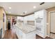 Spacious kitchen with a granite island, double oven, and custom white cabinets at 3614 Twisted Oak Ct, Lake Wales, FL 33898