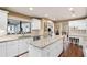 Bright kitchen featuring granite countertops, white cabinets, stainless appliances, and a view to the lanai at 3614 Twisted Oak Ct, Lake Wales, FL 33898