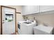Convenient laundry room with modern washer and dryer and utility sink at 3614 Twisted Oak Ct, Lake Wales, FL 33898