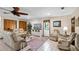 Cozy living room offers comfortable seating, a ceiling fan, tile floors and a tv at 3614 Twisted Oak Ct, Lake Wales, FL 33898