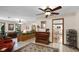 Inviting living room with a ceiling fan, tiled floors, a piano and an adjacent view into the kitchen at 3614 Twisted Oak Ct, Lake Wales, FL 33898