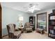 Comfortable living room featuring carpeted floors, chairs, and a window view at 3614 Twisted Oak Ct, Lake Wales, FL 33898