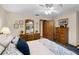 Charming main bedroom featuring a ceiling fan, wooden dresser, and decorative accents at 3614 Twisted Oak Ct, Lake Wales, FL 33898