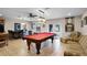 Spacious recreation room featuring a pool table, bar seating, and comfortable lounge area at 3614 Twisted Oak Ct, Lake Wales, FL 33898
