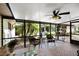Relaxing screened-in porch with brick floor, ceiling fan, and comfortable seating, offering an outdoor oasis at 3614 Twisted Oak Ct, Lake Wales, FL 33898