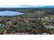 Overhead view with a red outlined property highlighting the lot size relative to a nearby lake and other houses at 3655 N Scenic Hwy, Lake Wales, FL 33898