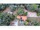 Expansive aerial view of home with an orange tile roof surrounded by lush greenery and outbuildings at 3655 N Scenic Hwy, Lake Wales, FL 33898