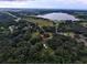 Aerial view of a home nestled among trees, showcasing the surrounding landscape and lake at 3655 N Scenic Hwy, Lake Wales, FL 33898