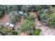 Birds eye shot of treed lot with metal outbuildings and the roof of the main home visible at the lower edge at 3655 N Scenic Hwy, Lake Wales, FL 33898