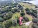 A nice aerial shot of the property nestled among the trees and with a partial lake view at 3655 N Scenic Hwy, Lake Wales, FL 33898