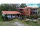 Aerial view of a two-story brick house with a lush backyard, patio, and mature trees at 3655 N Scenic Hwy, Lake Wales, FL 33898