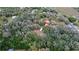 High angle shot of a residence tucked away on a sprawling treed lot surrounded by a lush, natural environment at 3655 N Scenic Hwy, Lake Wales, FL 33898