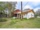 Exterior view of a home with a clay tile roof, showing the backyard with foliage and an aviary at 3655 N Scenic Hwy, Lake Wales, FL 33898