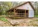 Rustic barn featuring aged wood, metal roof, and open stalls, resting on a concrete slab at 3655 N Scenic Hwy, Lake Wales, FL 33898