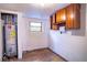 Utility room featuring a water heater, concrete walls, and storage space at 3655 N Scenic Hwy, Lake Wales, FL 33898