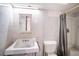 This bathroom features basic amenities, including a sink, toilet, medicine cabinet, and a shower stall with a curtain at 3655 N Scenic Hwy, Lake Wales, FL 33898