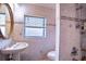 Bathroom featuring a pedestal sink, tile shower and walls, and a framed oval mirror at 3655 N Scenic Hwy, Lake Wales, FL 33898