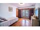 Bedroom with hardwood floors, a dresser, and a doorway to the outside at 3655 N Scenic Hwy, Lake Wales, FL 33898