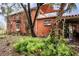 Rear exterior view of a two-story brick house with a terrace and lush greenery at 3655 N Scenic Hwy, Lake Wales, FL 33898