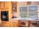 Eat-in kitchen featuring a built-in oven, wooden cabinets, and a desk overlooking the yard at 3655 N Scenic Hwy, Lake Wales, FL 33898