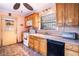 Well-lit kitchen with wooden cabinets, a double sink, and a view of the yard outside at 3655 N Scenic Hwy, Lake Wales, FL 33898