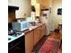 Functional kitchen with laminate countertops, white appliances, and a cozy rug at 3655 N Scenic Hwy, Lake Wales, FL 33898