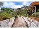 Charming walkway lined with lush landscaping and flowerbeds, adding curb appeal to this inviting home at 3655 N Scenic Hwy, Lake Wales, FL 33898