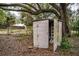 Outdoor storage shed with an open door for tools and equipment in a foliage-covered area at 3655 N Scenic Hwy, Lake Wales, FL 33898
