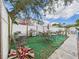 A view of the backyard patio with an outdoor dining set and green turf at 3690 Wellington Pl, Bartow, FL 33830