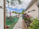 Charming backyard features an outdoor seating area with garden and lush tropical plants at 3690 Wellington Pl, Bartow, FL 33830