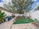 Spacious backyard with stone tile, an outdoor dining set, and lush tropical plants at 3690 Wellington Pl, Bartow, FL 33830