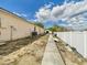A side yard with partial fencing and walkway at 3690 Wellington Pl, Bartow, FL 33830