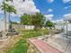 A view of the backyard with a stone path and tropical plants in a sunny area at 3690 Wellington Pl, Bartow, FL 33830
