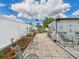 A view of the backyard with a patio and tropical plants in a sunny area at 3690 Wellington Pl, Bartow, FL 33830