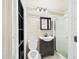 Clean bathroom featuring a sink, toilet, mirrored medicine cabinet, and a glass-enclosed shower stall at 3690 Wellington Pl, Bartow, FL 33830