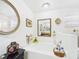 Bright bathroom featuring a white soaking tub with decorative accents and framed wall art at 3690 Wellington Pl, Bartow, FL 33830