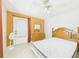 Bright bedroom with a wooden bed frame, dresser, and a door leading to the outside at 3690 Wellington Pl, Bartow, FL 33830