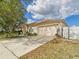 Well-maintained home with large driveway, mature trees, and lush landscaping at 3690 Wellington Pl, Bartow, FL 33830
