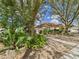A charming one-story home with mature trees and lush tropical plants in the front yard at 3690 Wellington Pl, Bartow, FL 33830